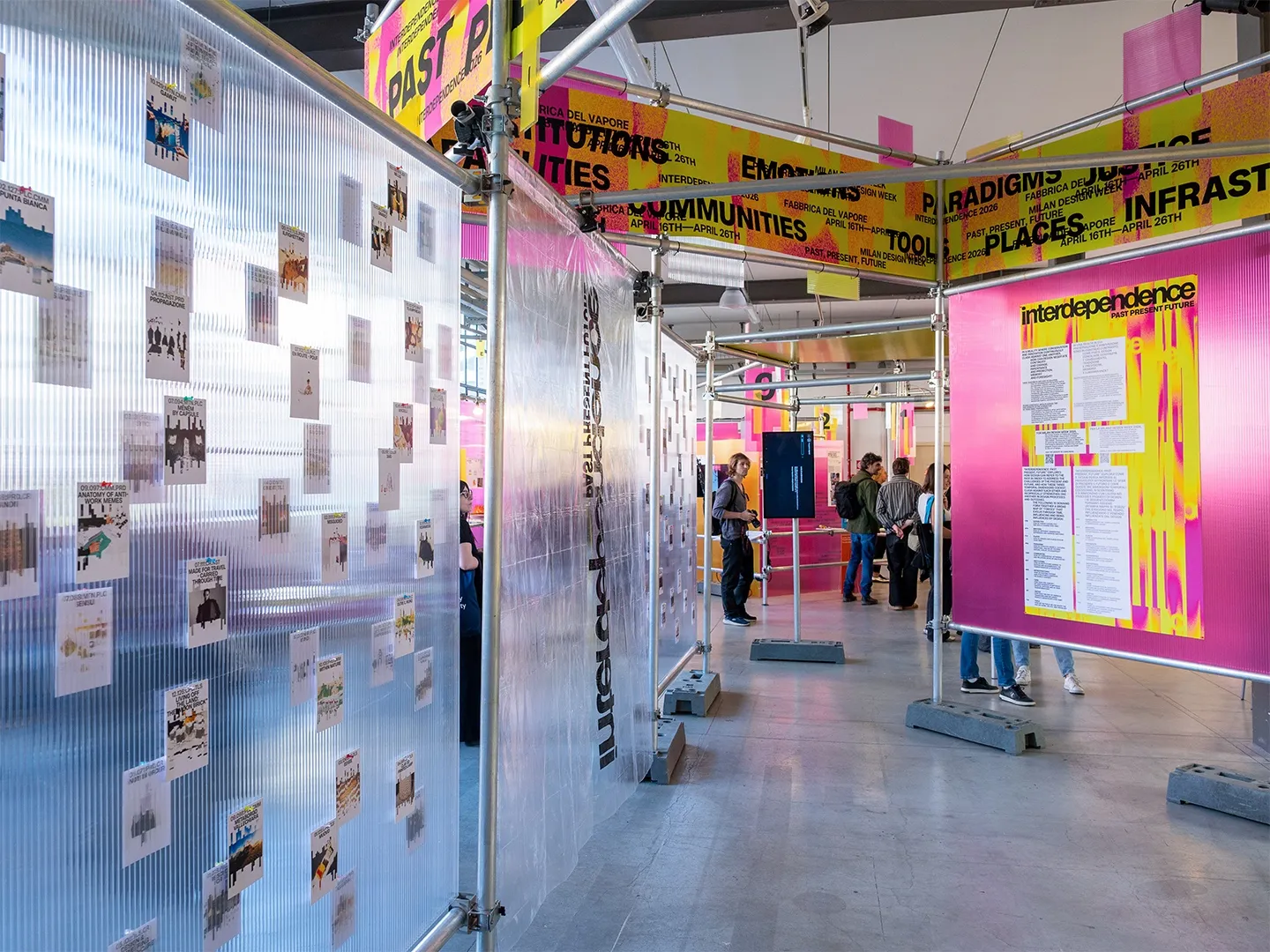 Exhibition structures with translucent walls covered in images and magenta panels