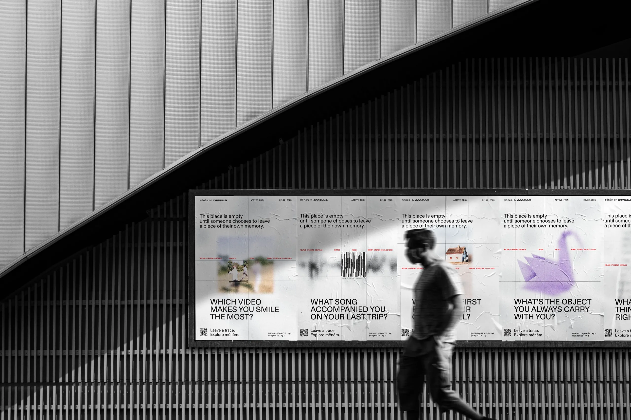A row of Capsule posters on a wall in an underpass, with a person walking past